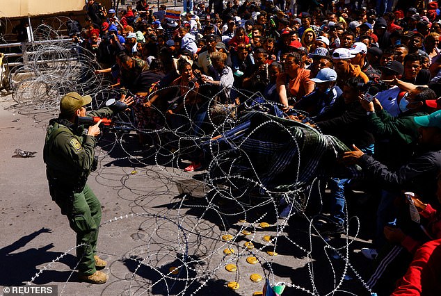 (Above) Migrants on the Paso del Norte International Bridge to seek asylum in the United States as seen from Ciudad Juarez, Mexico on March 12, 2023