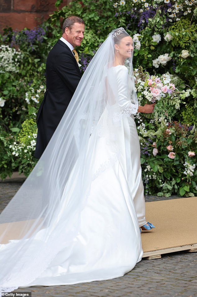 Olivia Henson smiles as she walks into Chester Cathedral for her wedding to Hugh Grosvenor, Duke of Westminster