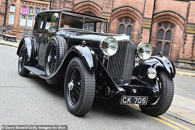 A Bentley Motors 1930 8-litre waits to chauffeur the Duke of Westminster and Miss Henson from their wedding at Chester Cathedral