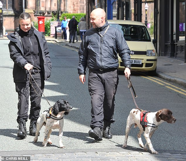 A large security cordon has been erected around the cathedral due to the presence of so many high-profile guests.  Pictured: sniffer dogs in Chester on Thursday