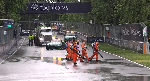 Stewards worked hard with leaf blowers to clear the track of standing water