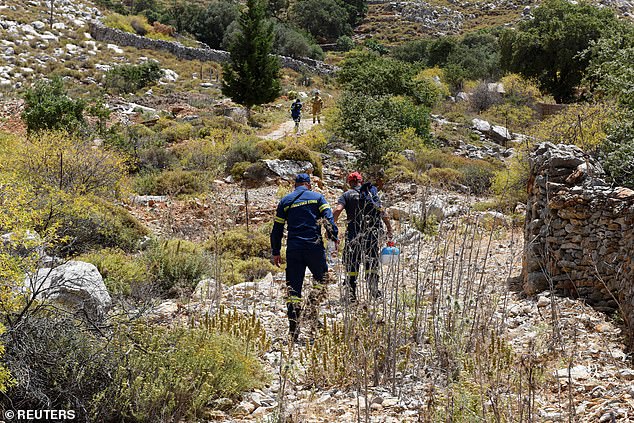 Firefighters inspect an area following the search for missing British TV doctor Michael Mosley