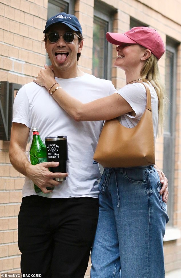 Justin managed to hold his lover while also juggling two drinks: a water bottle and a thermos with the humorous caption 'Tears Of My Pickleball Opponents'