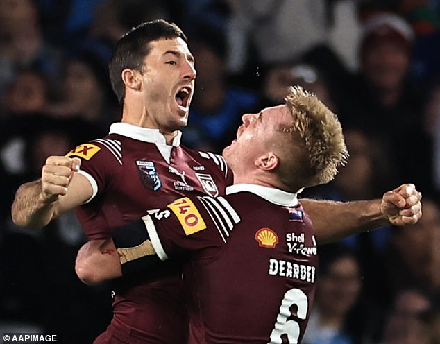 Hunt celebrates with Queensland teammate Tom Dearden after scoring a try against the New South Wales Blues on Wednesday night