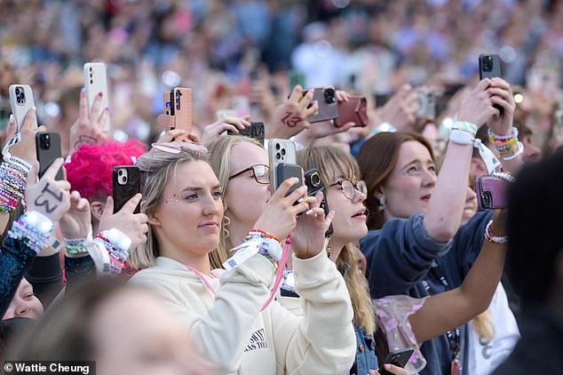 Swifties raised their phones in unison as the megastar took the stage to start the three-hour show