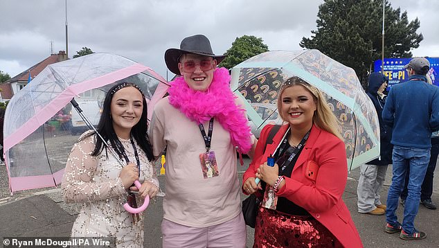 Fans brought umbrellas and waterproof jackets to protect their carefully planned outfits from the rain in Scotland