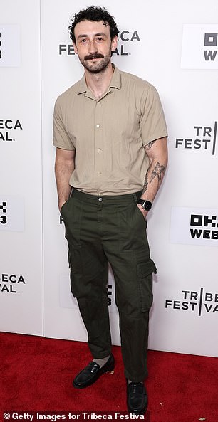 Adam Weiss wore a tan short-sleeved button-down shirt, which he tucked into green cargo pants with black loafers