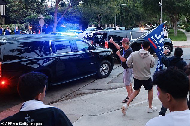 Supporters chase the motorcade as Trump leaves the fundraising dinner in Beverly Hills