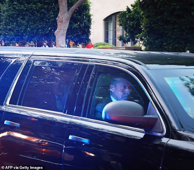 Trump could be seen waving to his supporters gathered on the side of the road