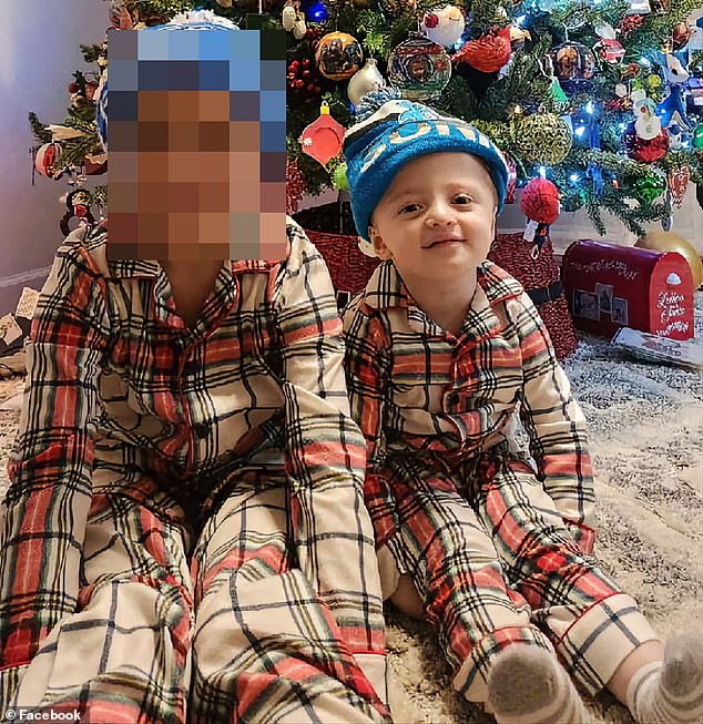 Julian (right) with his older brother at Christmas 2022 when he was two years old