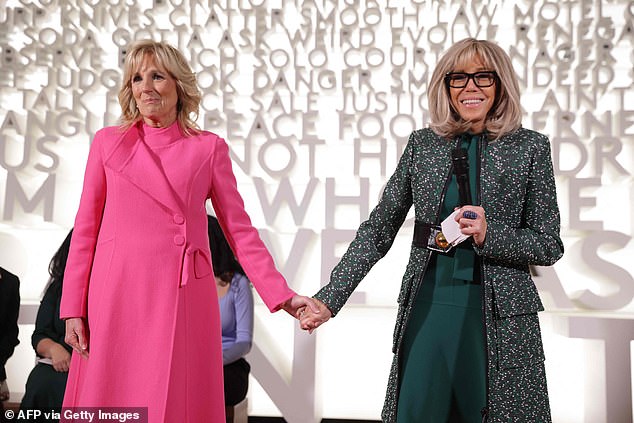 Jill Biden and Brigitte Macron hold hands while visiting the Planet Word Museum in Washington DC in December 2022