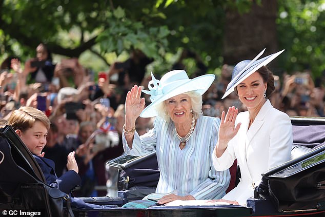 In 2022, Kate opted for a white blazer-style dress with sharp lapels and a flared Alexander McQueen skirt, previously worn in 2017, with a white and blue Philip Treacy hat.  Camilla also recycled a previously worn outfit, opting for a blue striped dress from Bruce Oldfield with a hat, also from Philip Treacy