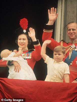 Queen Elizabeth waves alongside her husband Prince Philip and son Prince Andrew as she holds baby Prince Edward during Trooping the Color in 1964