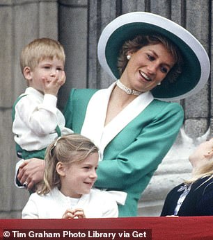 Diana on the balcony of Buckingham Palace with a young Prince Harry in 1988