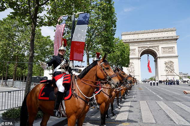 The French Republican Guard stands in front of the Arc de Triomphe before a welcome ceremony with the French president and the US president in Paris