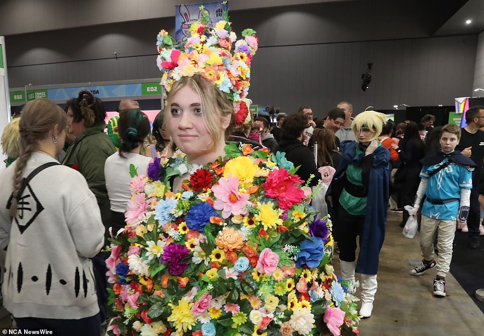 This visitor was covered in a cape of bright flowers with a matching flower crown