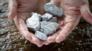 Miners hold platinum, silver or rare earth minerals from the mine in their hands for inspection and consideration