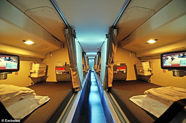 A crew rest area on an Emirates Airlines plane, with wide beds and privacy curtains