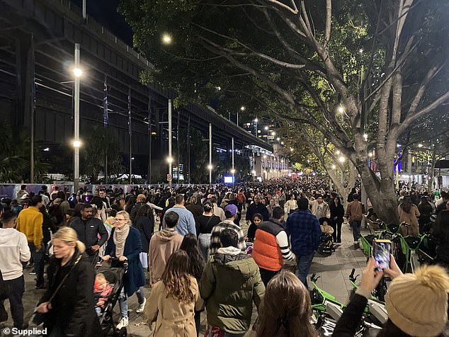 A crowd is shown gathering on Circular Quay, near George Street