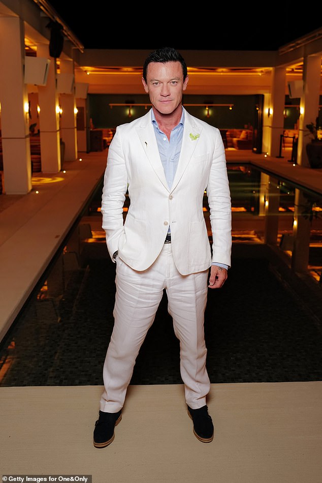 Hollywood star Luke Evans cut a suave figure in a white suit combination and baby blue shirt