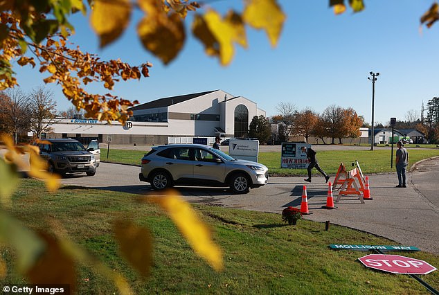 A law enforcement officer mans a checkpoint next to the Sparetime Recreation, one of two locations targeted by the mass shooter