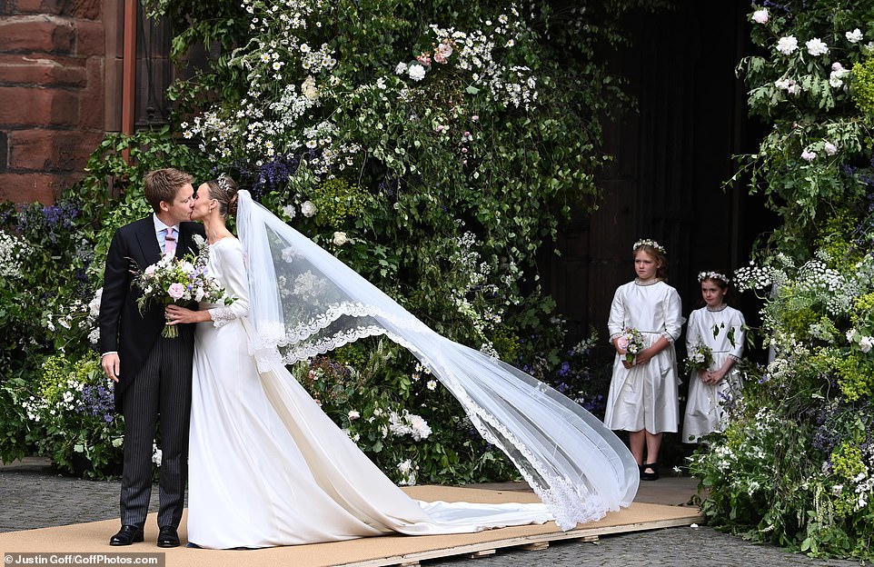 The Duke of Westminster and Olivia Henson kiss after getting married at Chester Cathedral