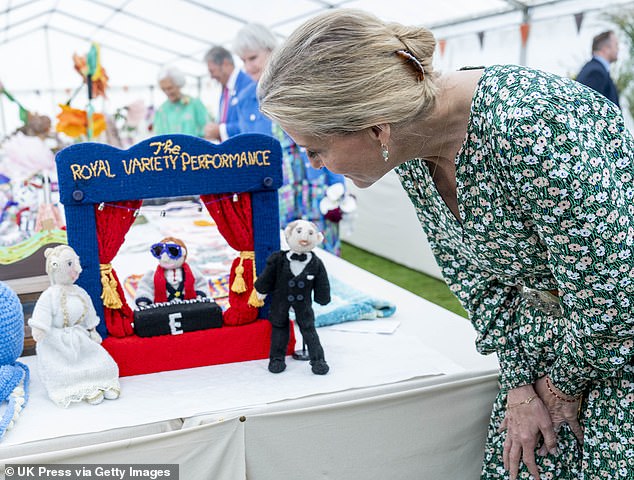 The knitted display was created by residents of Brinsworth House in Twickenham (photo: Sophie looking at knitted figures of herself and Prince Edward)