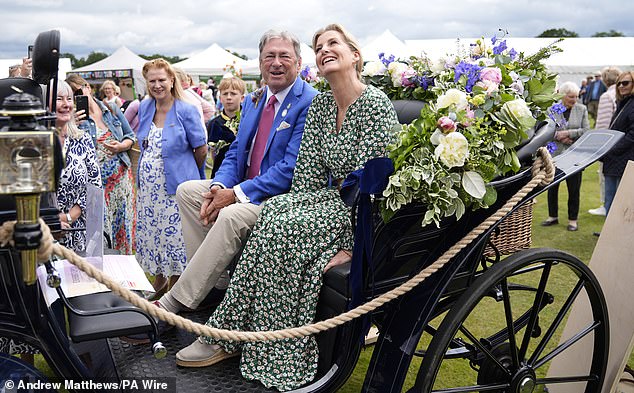 The royal was photographed sitting in a carriage next to the event's honorary chairman, Alan Titchmarsh