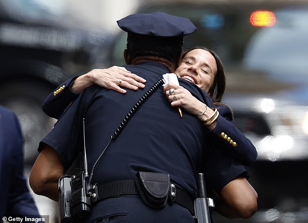 Ashley Biden, the daughter of US President Joe Biden, hugs a police officer as she leaves the J. Caleb Boggs Federal Building during the trial of her brother Hunter Biden