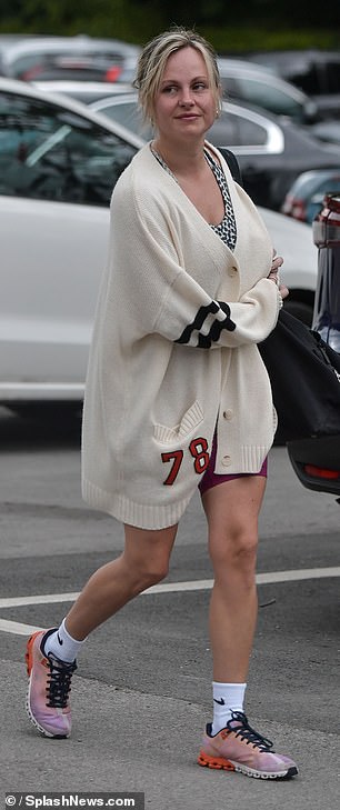 She completed the look with a pair of pastel sneakers and white Nike socks, and further accessorized with a pair of gold statement earrings