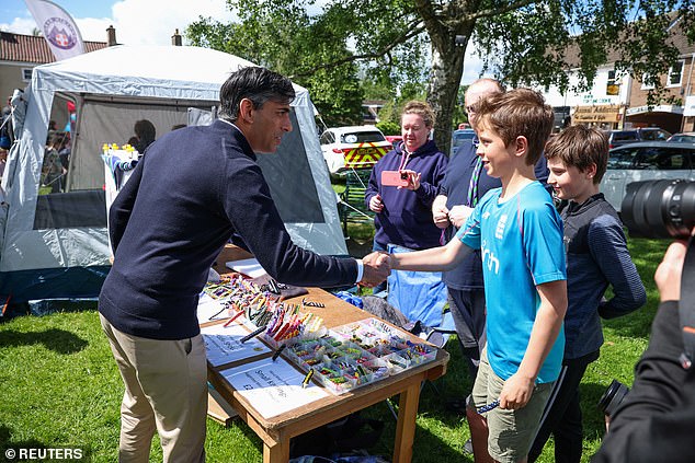 Mr Sunak pictured himself shaking hands with a boy during a Conservative election campaign in Great Ayton today