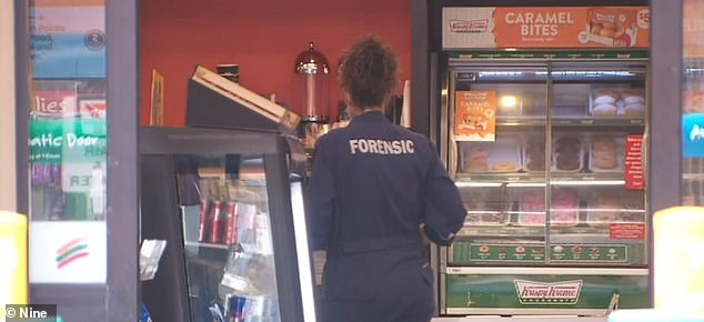 Forensic officers are seen at the petrol station after Mrs Murphy was attacked