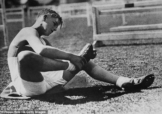 Philip attended the Scottish boarding school Gordonstoun, where he flourished.  Above: The future Duke of Edinburgh checks his running shoes during an inter-school sports day in 1935