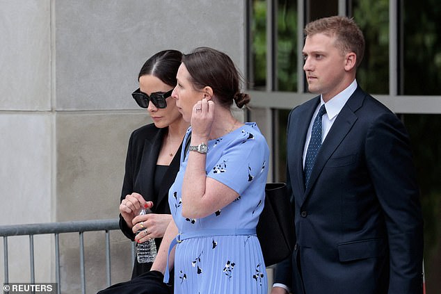 Naomi Biden, in black at left, is followed out of the Wilmington, Del., courthouse.  by husband Peter Neal