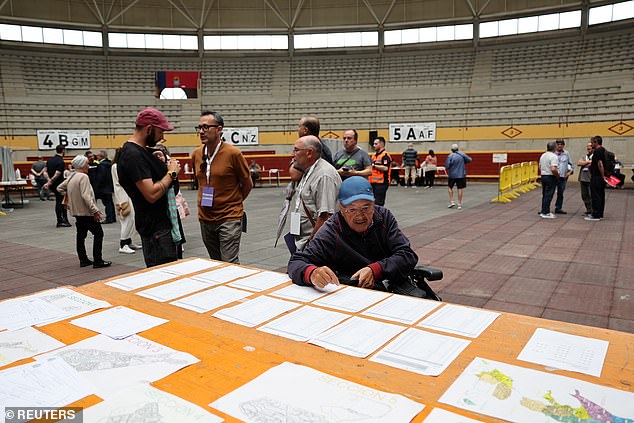 A voter searches for his polling station during the European Parliament elections in Moralzarzal, Spain