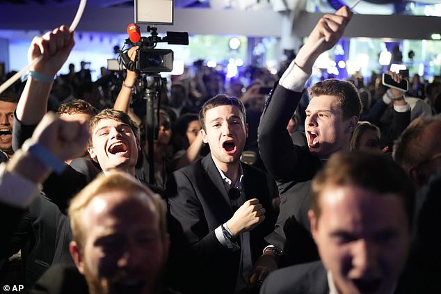 Supporters of France's far-right National Rally react at party election headquarters after French President Emanuel Macron announced he would dissolve the National Assembly