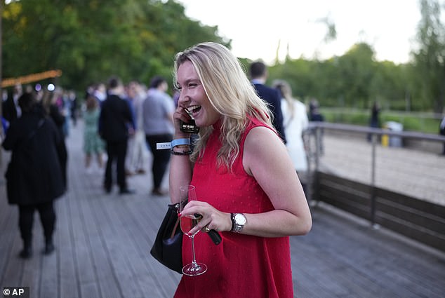 One woman was seen happily drinking as Macron called early elections