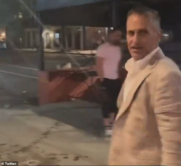 The banker, seen here triumphantly turning in the wake of the attack, works as a Managing Director at Moelis & Company, a leading investment bank with offices in Midtown Manhattan