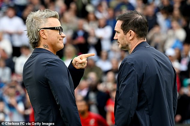 The singer appeared to be deep in conversation with Frank, 45, ahead of the star-studded match