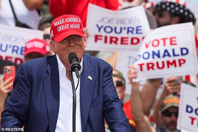 AOC urges Trump critics to take the former president at his word when he makes threats.  Trump is pictured at a campaign event in Las Vegas, Nevada