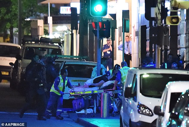 Paramedics are pictured at work at the end of the siege at the Lindt Cafe on December 16, 2014