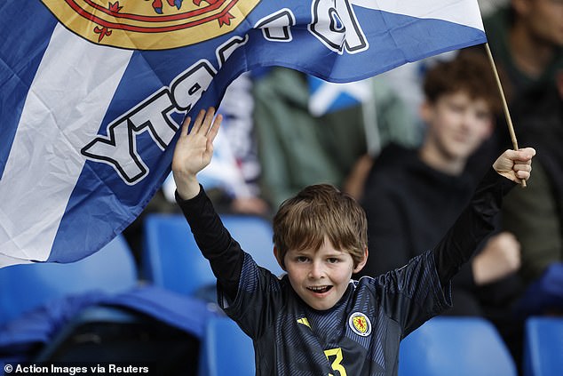 A young supporter shouts his appreciation for Scotland before the match against Finland