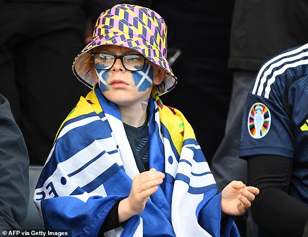 A colorfully dressed youngster can't wait for the action to start in Hampden