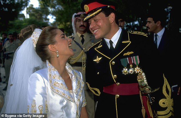 Despite tradition that dictates that royal brides wear family jewels, Rania, born into a humble Palestinian family in Kuwait, made a statement by wearing a simple, embellished headband on her veil, symbolizing her roots.  Above: The couple beams at each other on their wedding day