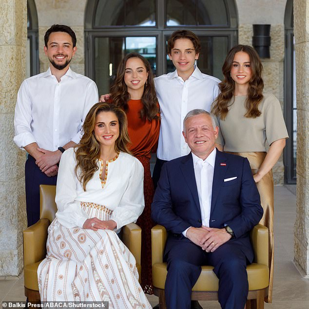 King Abdullah and Queen Rania of Jordan pictured with their children (from left to right) Prince Hussein, Princess Salma, Prince Hashem and Princess Iman, December 2022