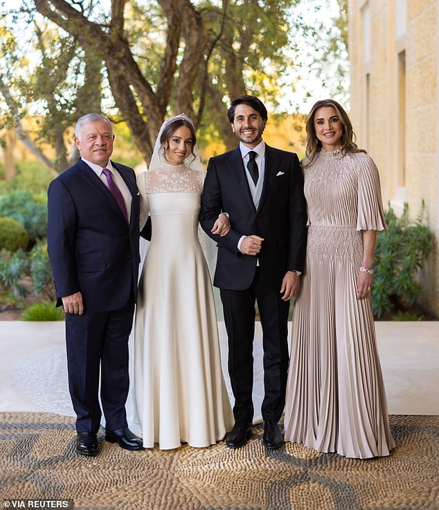 King Abdullah and Queen Rania pose for a photo with the bride and groom, their eldest daughter Princess Iman and Jameel Alexander Thermiotis in March 2023