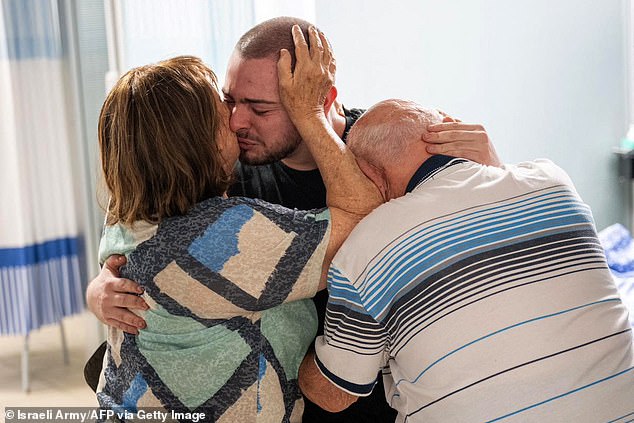 Almong Meir Jan, 22, is seen crying as he is greeted by his close relatives at the Sheba Tel-HaShomer Medical Center, following his rescue from the Gaza Strip by the Israeli army on Saturday