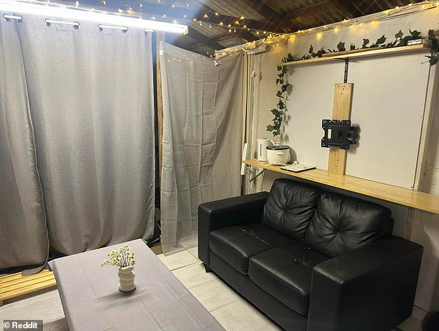 The home features a makeshift lounge (pictured) equipped with a small sofa, a table and illuminated by string lights draped over the plastered walls.