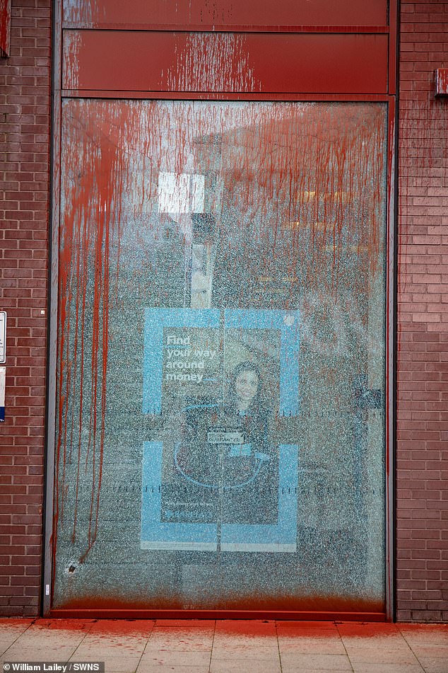 BURY: A cracked window in a Barclays bank in Manchester, dripping with red paint