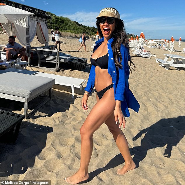 The Real Housewives Of New Jersey highlight was on the beach wearing her dark hair down with a shirt falling off her shoulders